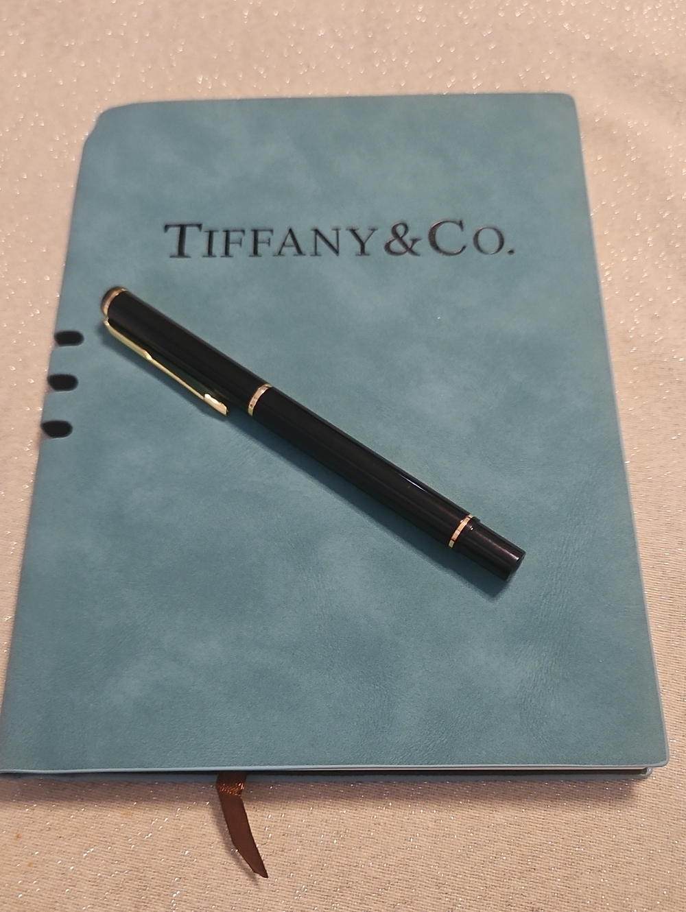 Tiffany & Co. Blue Notebook with Black Pen and Gold Accents